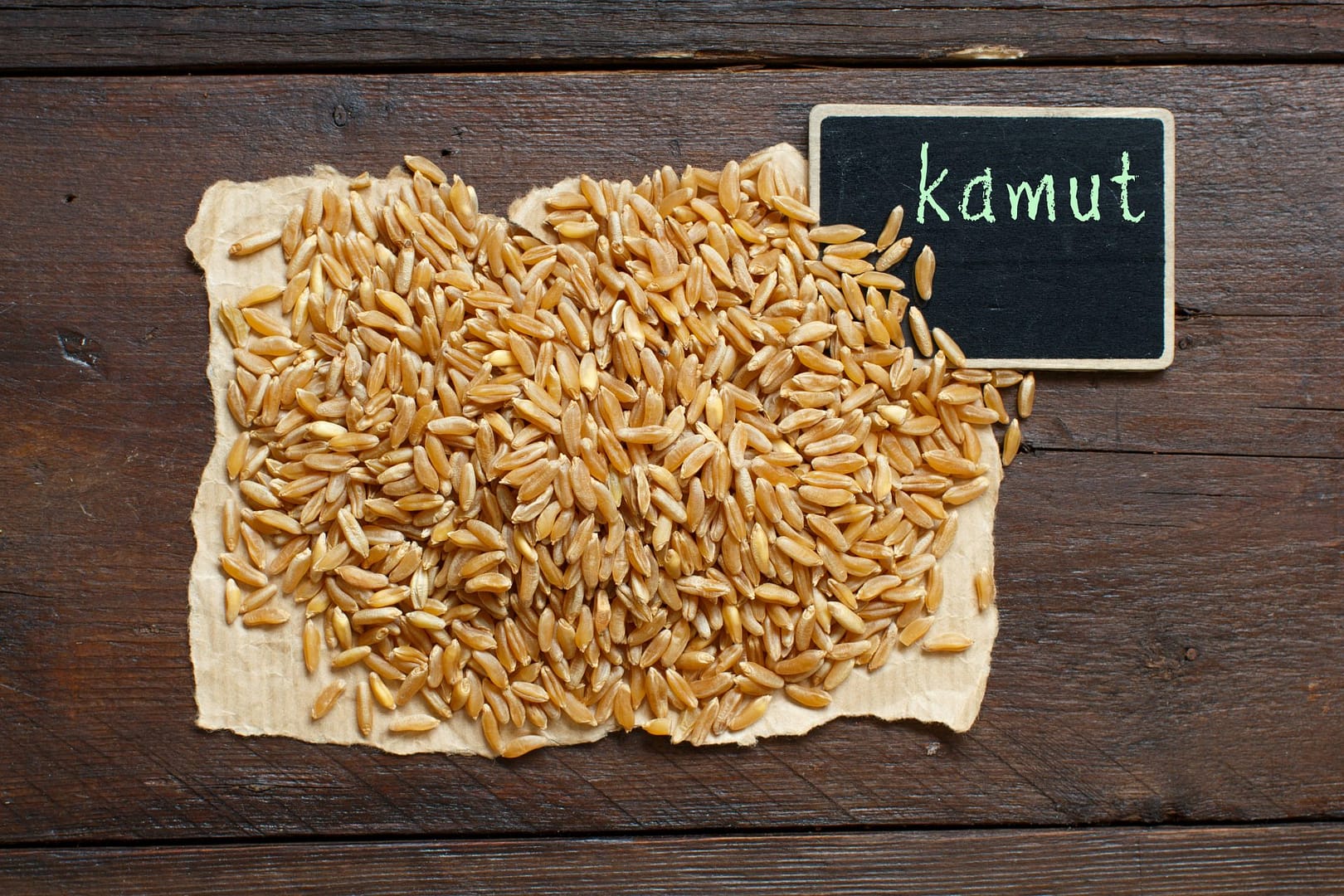 pile-of-kamut-grain-with-a-small-chalkboard-2023-11-27-05-11-20-utc